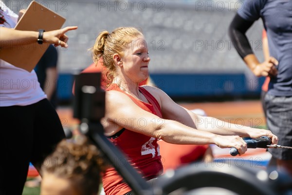 Woman using rowing machine outdoors