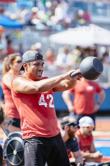 Man lifting kettlebell outdoors