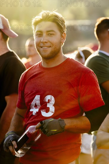 Portrait of smiling Caucasian man holding water bottle