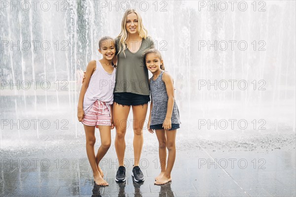 Sisters posing near fountain