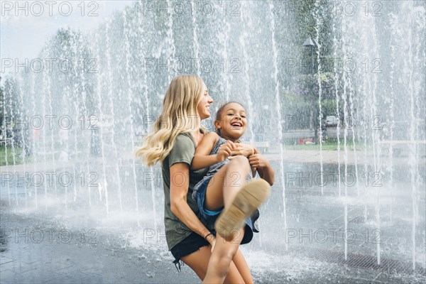 Sisters playing near fountain