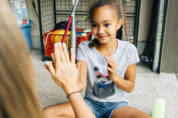 Sisters playing hand clapping game