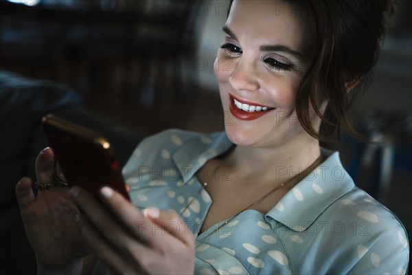 Woman texting on cell phone in the dark