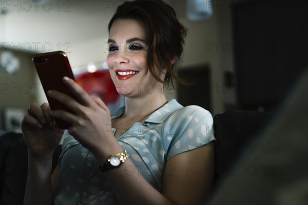 Woman texting on cell phone in the dark