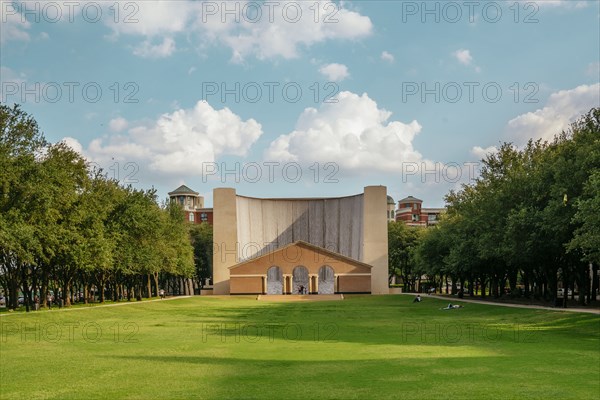 Scenic view of tree-lined lawn near building