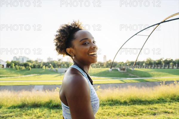 Portrait of smiling mixed race woman in park