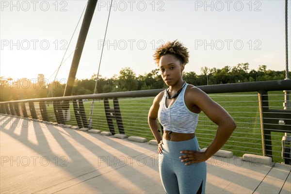 Mixed race woman resting on bridge