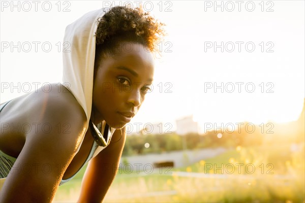 Mixed race woman resting with towel on head