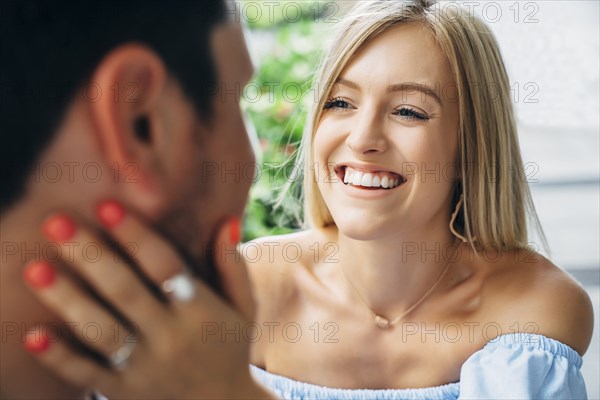 Smiling Caucasian woman embracing man