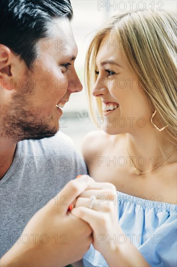 Smiling Caucasian couple holding hands