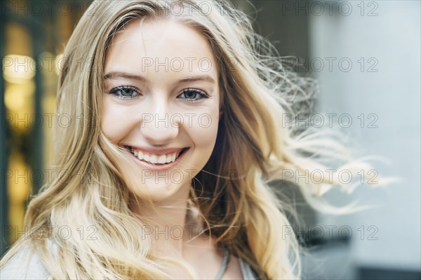 Wind blowing hair of smiling Caucasian woman