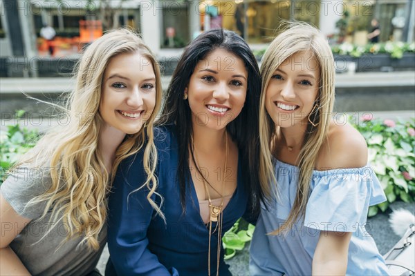 Wind blowing hair of smiling women