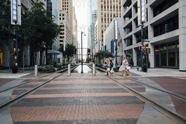 Friends crossing street in city