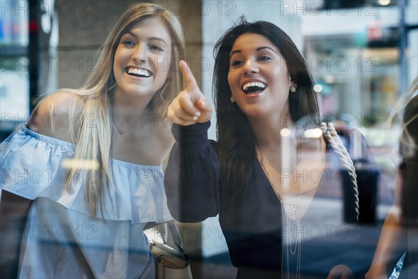 Smiling women window shopping