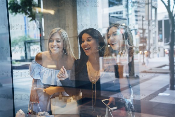 Smiling women window shopping