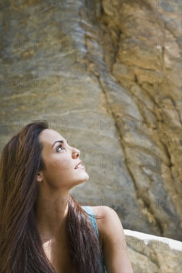 Hispanic woman looking up