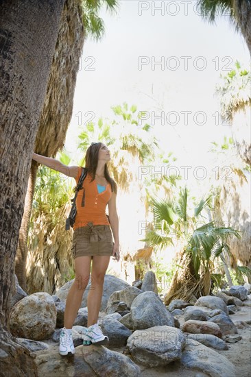 Hispanic woman hiking in tropical area