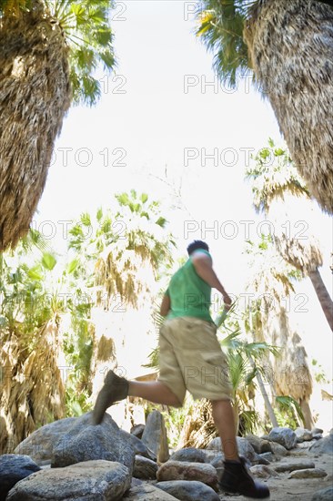 Hispanic man hiking in tropical area