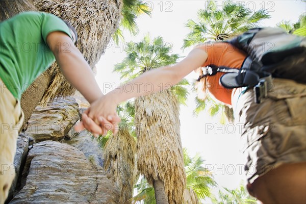 Hispanic couple hiking in tropical area
