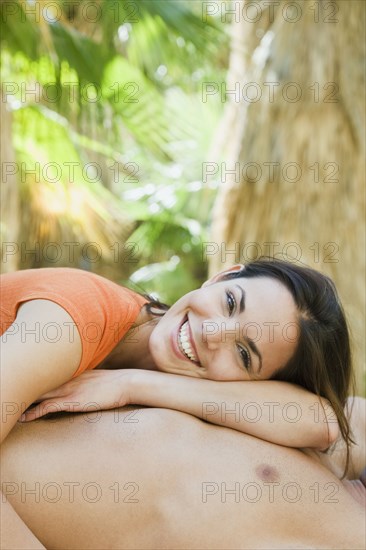 Hispanic couple relaxing in tropical area