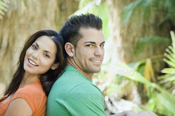 Hispanic couple relaxing in tropical area