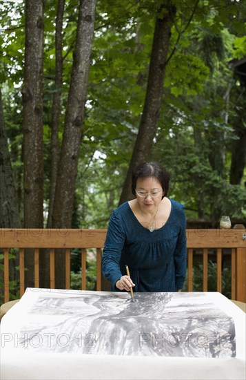 Chinese woman painting outdoors