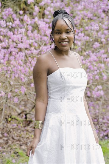 Mixed race woman wearing dress in garden