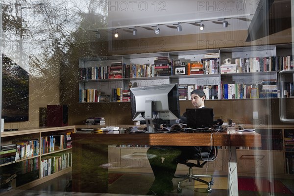 Mixed race businessman sitting at desk