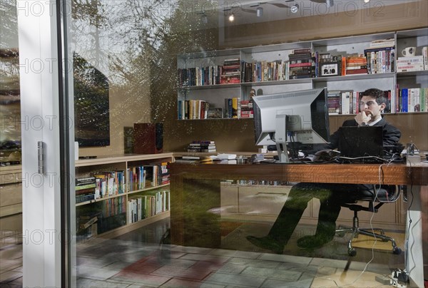 Mixed race businessman sitting at desk