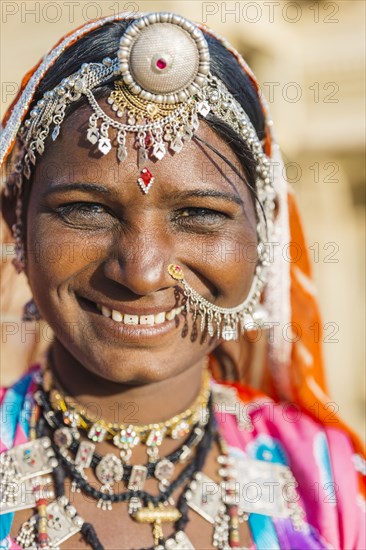 Smiling Indian woman wearing traditional jewelry