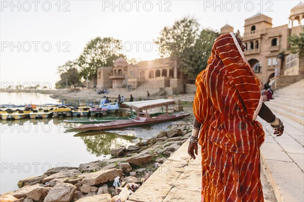 Indian woman walking at waterfront