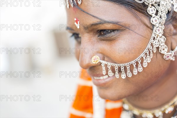 Close up of Indian woman wearing traditional jewelry