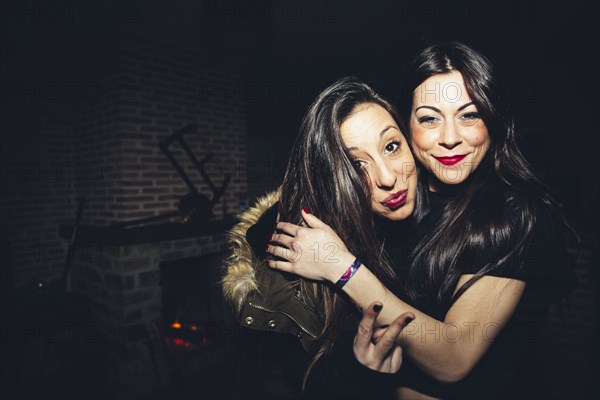 Smiling women hugging at party