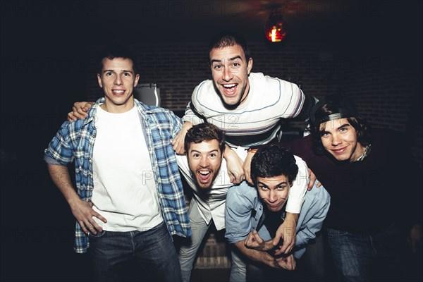 Laughing men posing at party at night