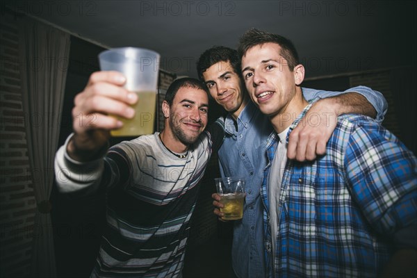 Smiling men drinking in nightclub