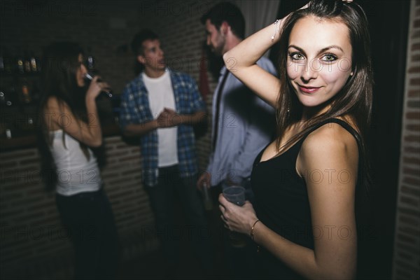 Smiling woman dancing in nightclub