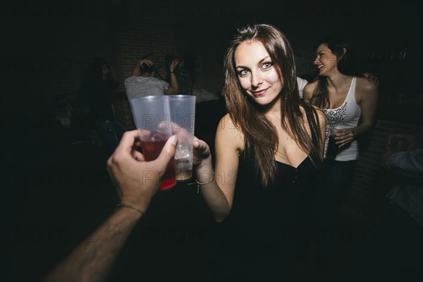 Friends toasting and drinking in nightclub