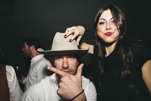 Friends smiling and playing in nightclub