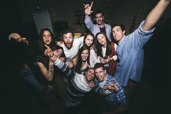 Smiling friends posing in nightclub