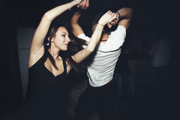 Happy couple dancing in nightclub