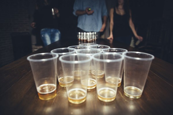 Friends playing beer pong at party