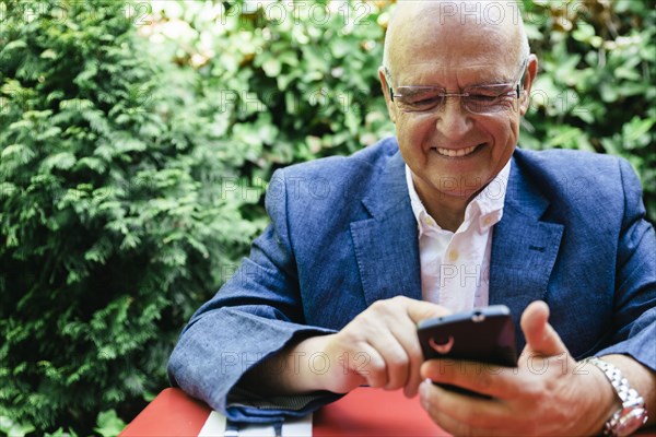 Hispanic businessman using cell phone