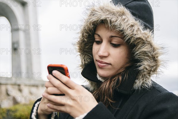 Caucasian woman using cell phone