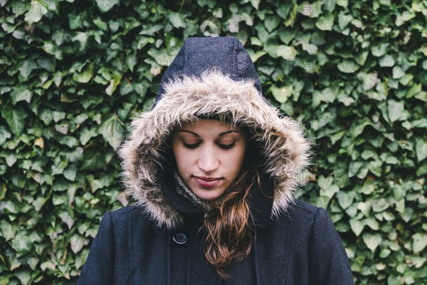 Caucasian woman wearing fur hood