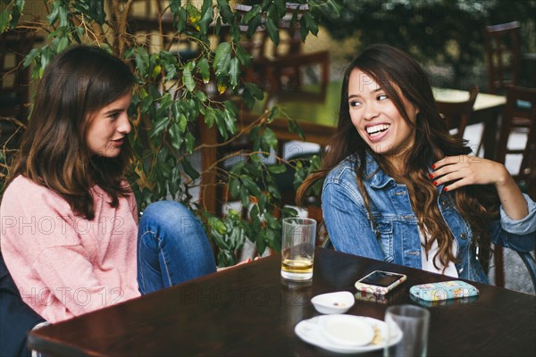 Women talking in outdoor cafe