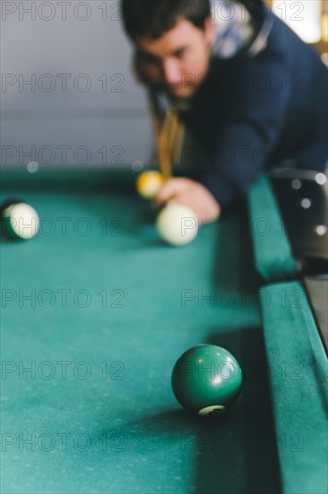 Hispanic man playing pool