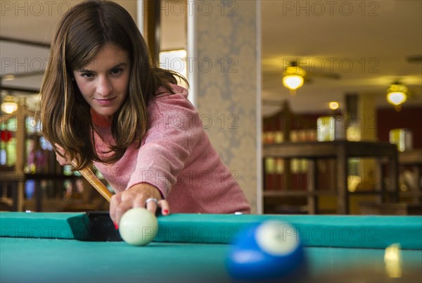 Caucasian woman playing pool