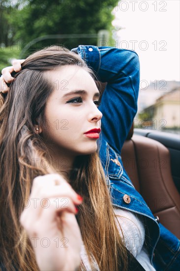 Caucasian woman sitting in convertible