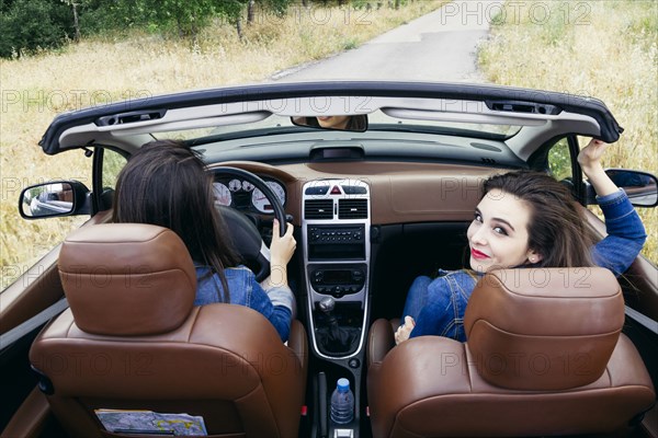 Women driving in convertible