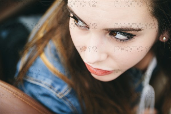 High angle view of Caucasian woman looking over shoulder